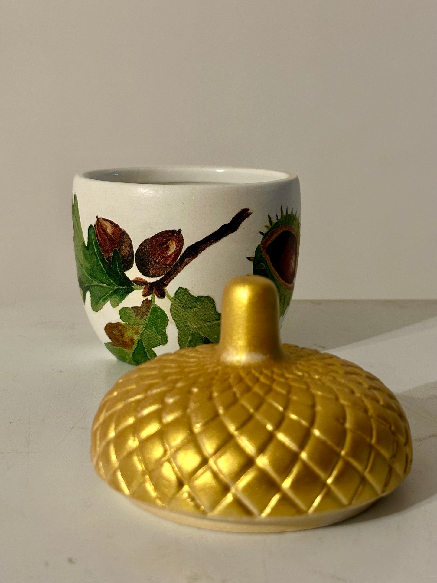 Ceramic acorn pot with gold lid