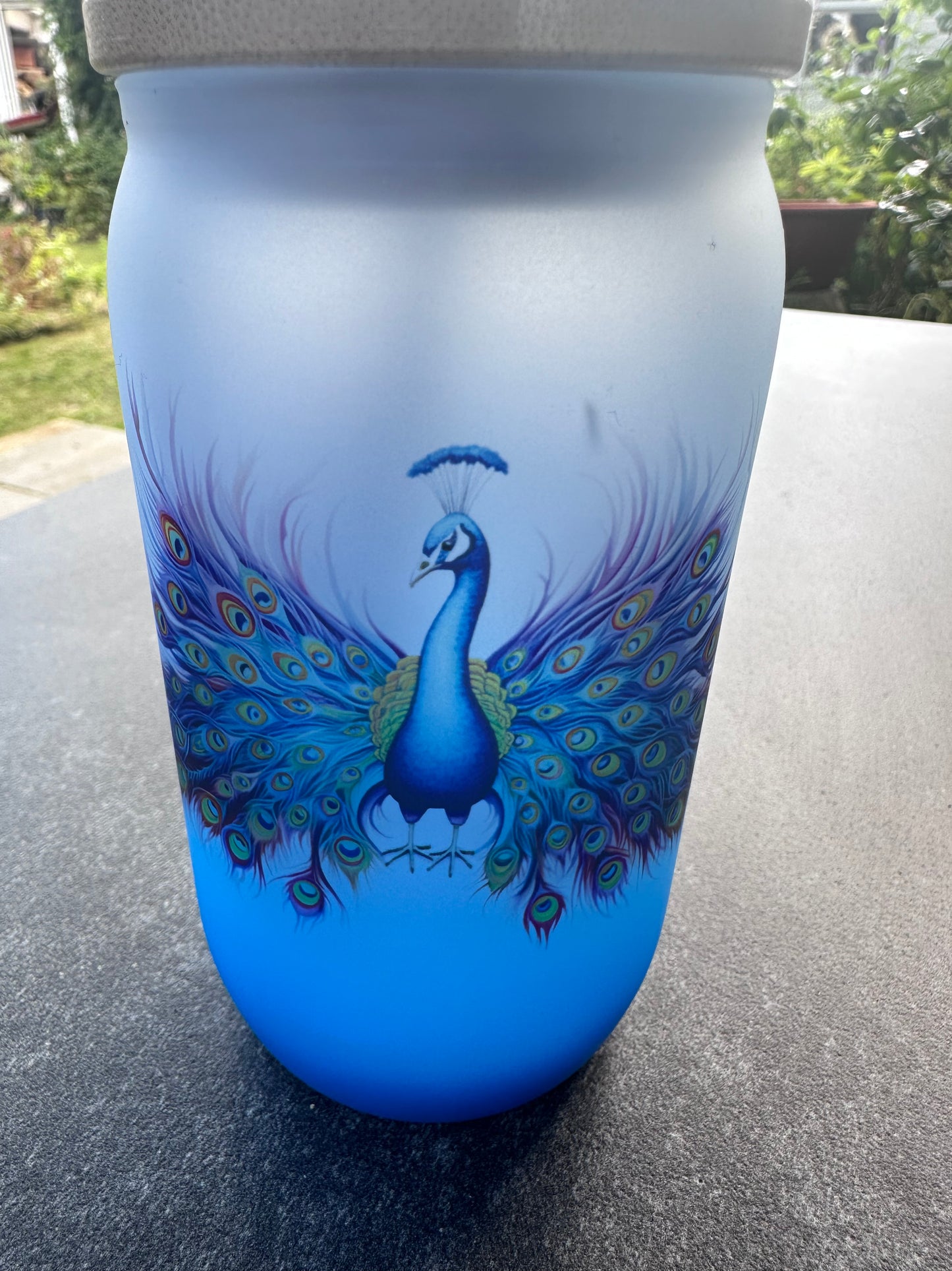 Blue ombré glass tumbler with peacock design