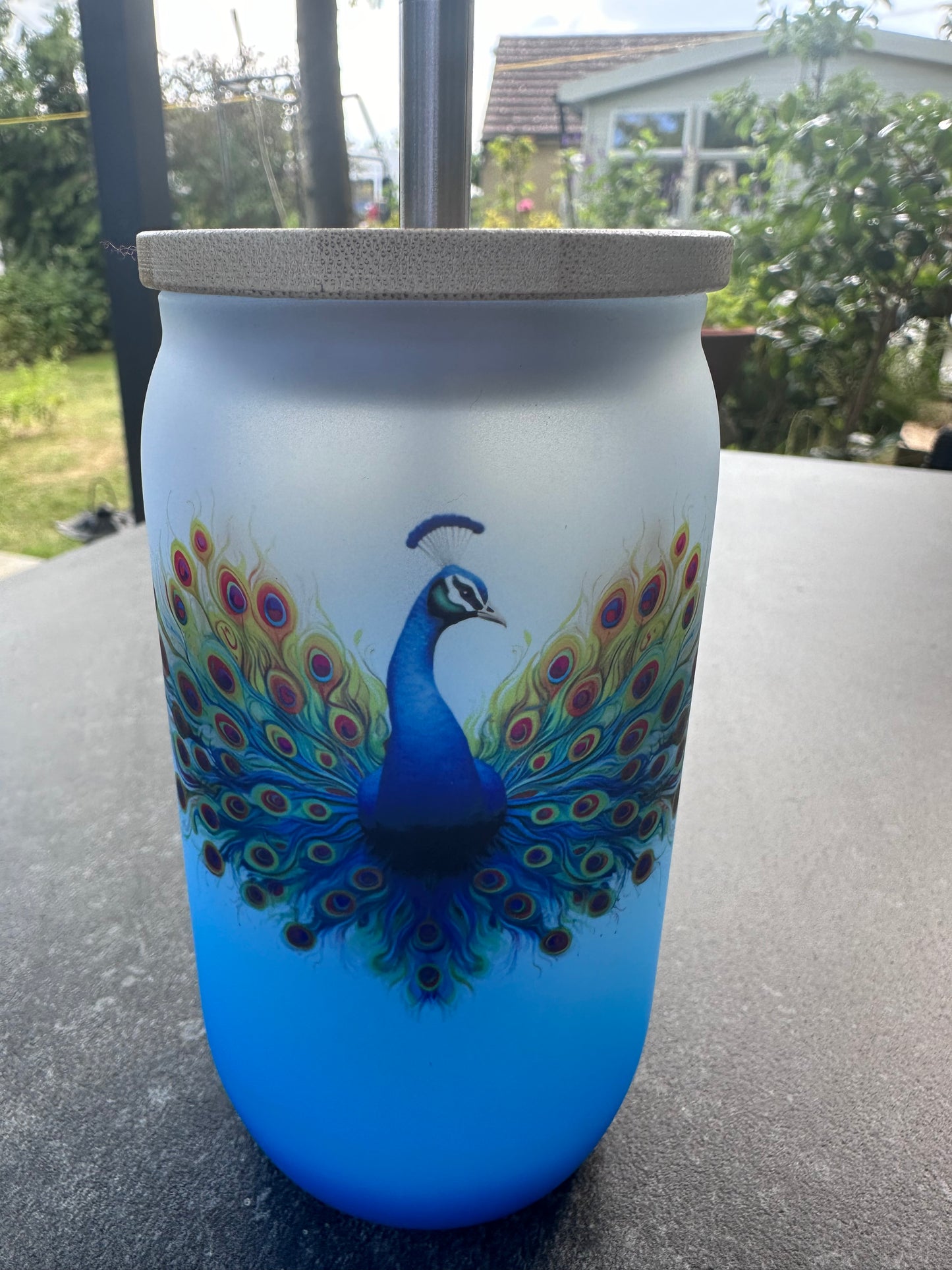 Blue ombré glass tumbler with peacock design