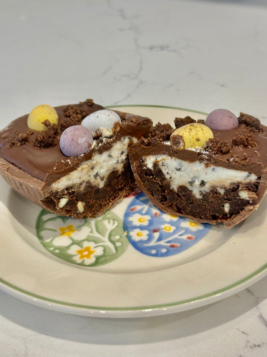 Half a chocolate Easter egg filled with cookies and cream filling or salted caramel.